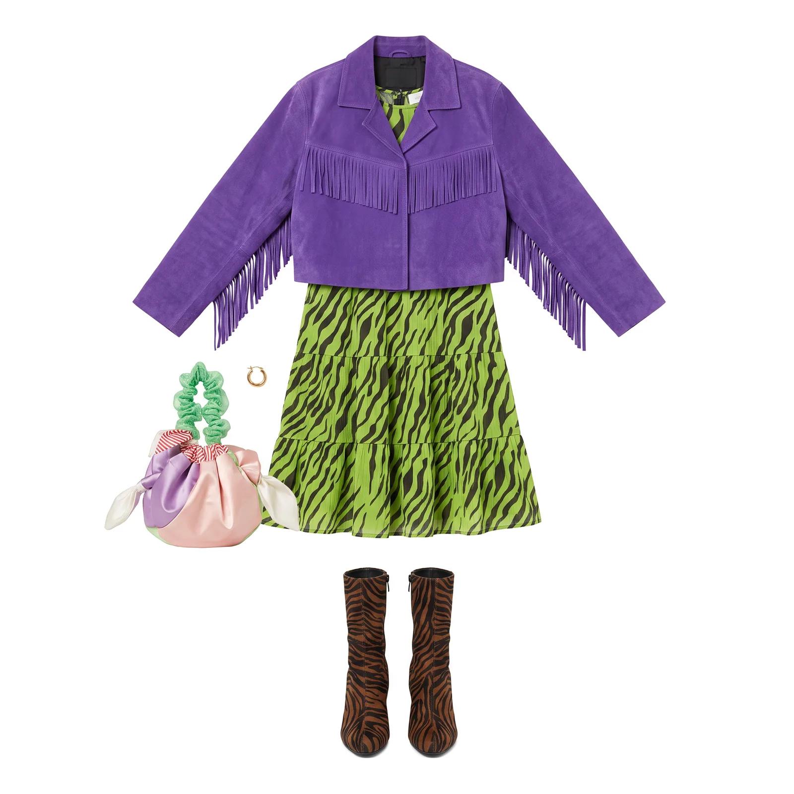 Flat-lay outfit on a white background: a cropped purple suede jacket with fringe, a green and black zebra-print tiered dress, a satin knot bag with a ruffled green handle, a gold hoop earring and zebra-print ankle boots.