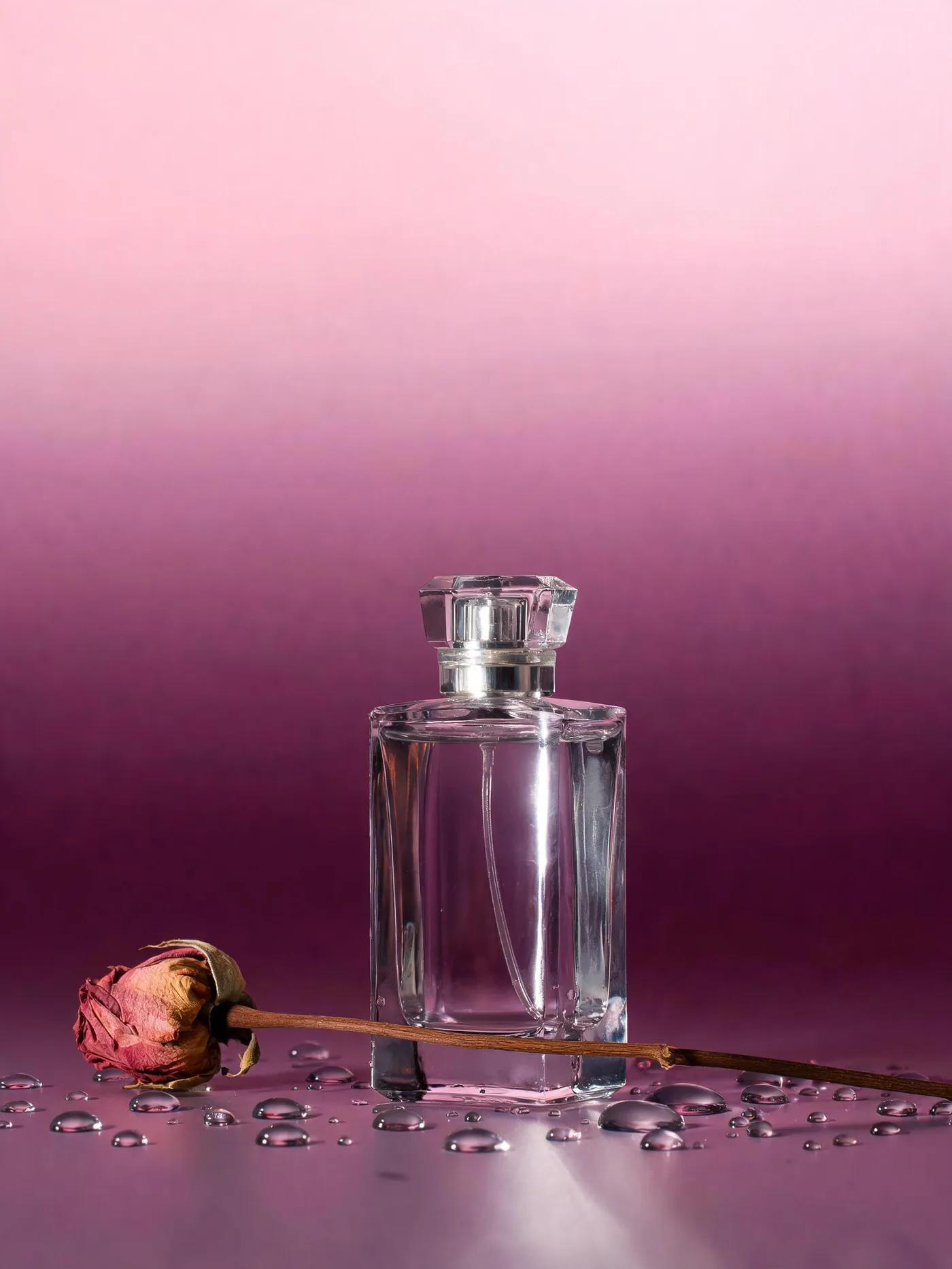 A fragrance key visual generated by Seedream 5.0 Lite — a faceted glass bottle on a graded blush-to-plum backdrop with studio specular highlights.
