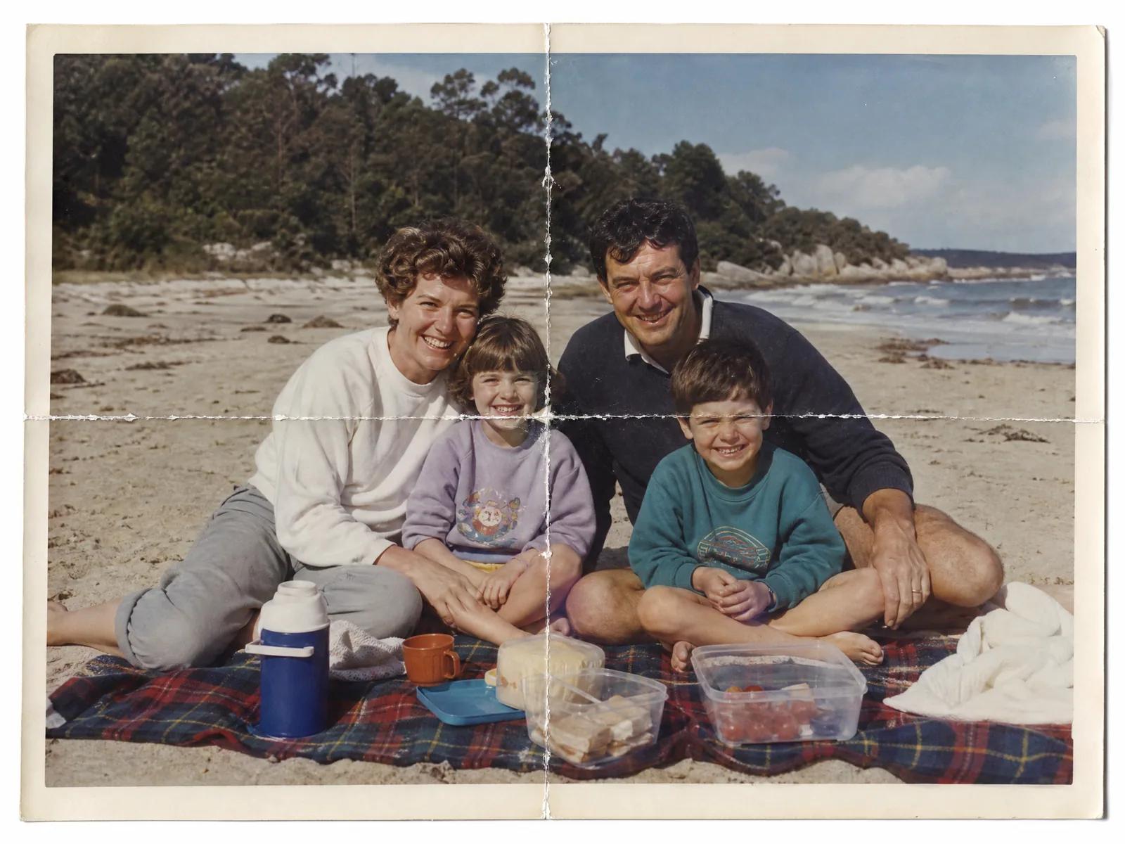 A scan of an old family beach photo with two white fold lines crossing in the middle.