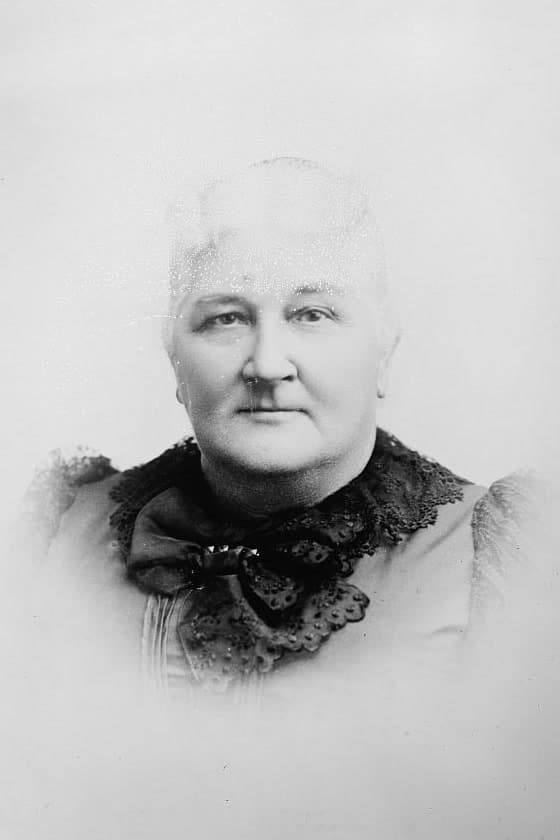 A black-and-white studio portrait of an older woman with a lace collar, taken between 1910 and 1935.
