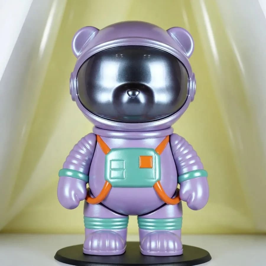 A product-style render made from a text prompt with Grok Imagine — a lavender astronaut bear designer toy with mint and orange details on a pastel yellow set.